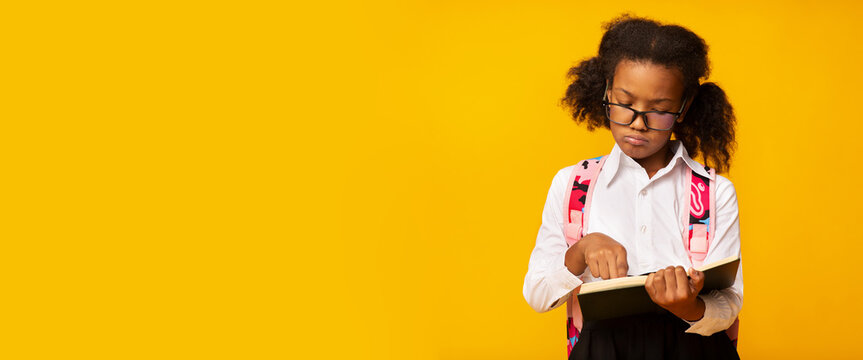 African American Schoolgirl Learning Reading Book Over Yellow Background, Panorama
