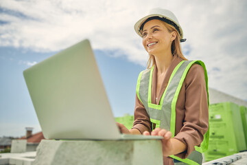 Female constructor sitting at a building site