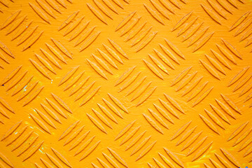 Sheet metal with hatched pattern painted a bright yellow colour