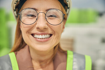 Cute blonde engineer smiling at the camera