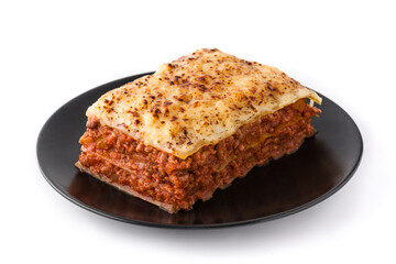 Piece of meat lasagna on black plate isolated on white background