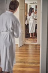 Charming young female is standing in bathroom