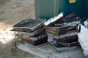 Many discarded portable barbecues 