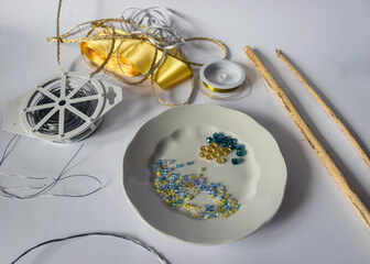 various tools and accessories for making a pearl crown, handmade, spending free time at home, cutlery