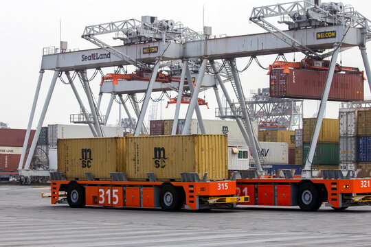 Automated vehicles moving shipping containers to and from gantry cranes in the Port of Rotterdam, The Netherlands, September 6, 2013.