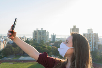 Woman wearing mask taking a selfie