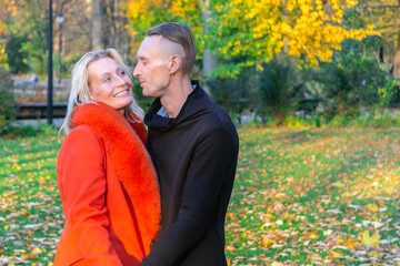 Lovely pair having fun in colorful autumn park