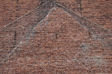 old brick wall with traces of the house that stood next to it and was demolished. outlines of the...