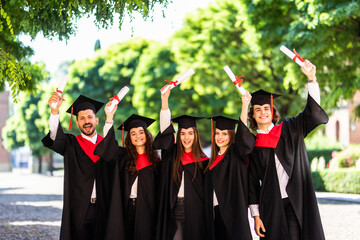 Education, graduation and people concept. Group of happy international students in mortar boards...