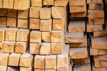 parallel stacked stack of beams beige background vertical pile base building many pine boards dried