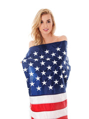 Beautiful blond woman wrapped only in an American flag.