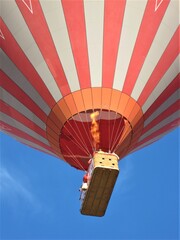 Hot air balloon from below against a blue sky
