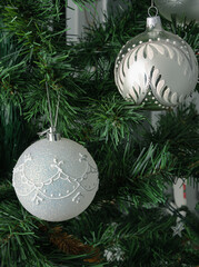 two shiny white balls on christmas tree.Christmas card with decorated element. Vertical orientation