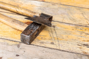 old working tools ax and hammer lie on wooden surface background construction