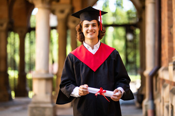 Graduate male student. Graduation concepts. Portrait of young man on graduation day at University....