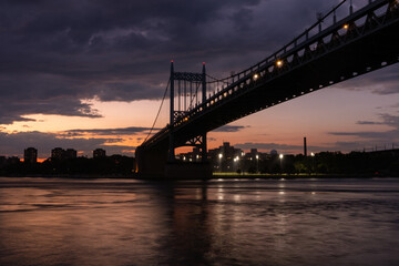 Fototapeta na wymiar Triborough Bridge during a Beautiful Sunset over the East River connecting Astoria Queens New York to Wards and Randall's Island