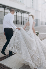 Fototapeta premium the bride and groom walk and hold hands