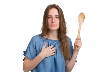 A young woman with long hair in a blue dress. with a large wooden spoon. Isolated on a white background