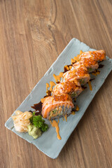 California salmon sushi rolls stuffed with salmon, avocado, topping salmon roe and spicy cream sauce. Japanese food style