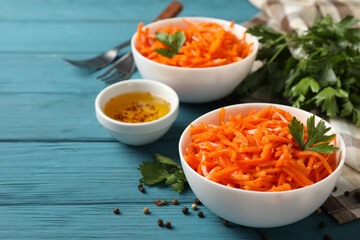 Composition with tasty carrot salad on wooden background. Korean carrot