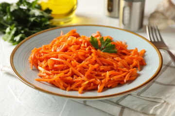 Composition with tasty carrot salad on white background. Korean carrot