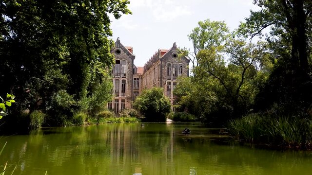 The old military headquarters and high school college building reflected over the lake at Parque D. Carlos I, in Caldas da Rainha, Silver Coast, Portugal
