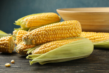 Composition with fresh raw corn on wooden table
