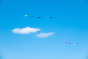 Child's toy kite flying in a clear blue summer sky