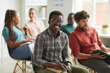 Multi-ethnic group of people sitting in audience during training seminar or business conference in...