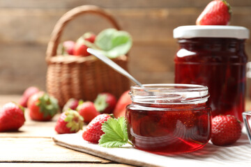 Delicious pickled strawberry jam and fresh berries on wooden table