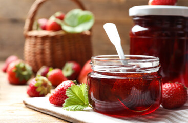 Delicious pickled strawberry jam and fresh berries on wooden table