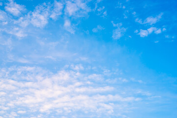 Blue summer sky with soft clouds