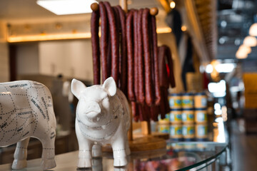 White ceramic pig figurine and sausage