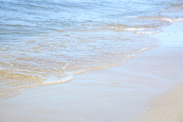 Beautiful sea waves on sandy beach, closeup