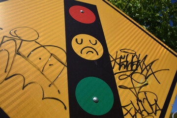 Traffic light signal with graffiti.