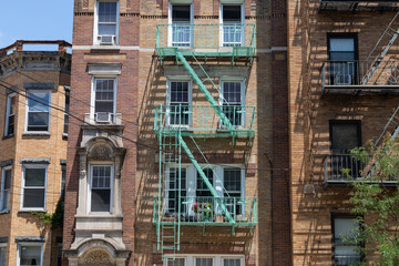 Fototapeta na wymiar Old Brick Apartment Buildings with Fire Escapes in Astoria Queens New York