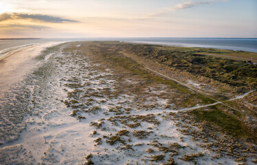 Fototapeta na wymiar Drones View over the sand dunes and the sandy beach of the island Juist in the North Sea in summer.
