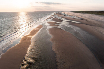 Drones View over the sandy beach and tidal channels of the island Juist in the North Sea in summer.