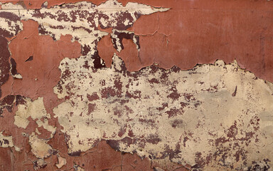 old red wall with peeling paint - rough dirty texture for a background	
