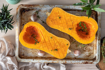 Tray with fresh raw butternut squash pumpkin and herbs