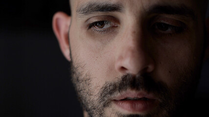 Obraz premium Portrait of worried man. Caucasian man in low key light, shallow depth of field