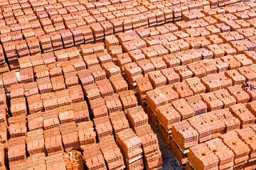 Pallets with bricks in a warehouse of a brick factory. View from above