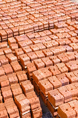 Pallets with bricks in a warehouse of a brick factory. View from above