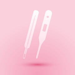 Paper cut Classic Medical thermometer and digital thermometer for medical examination icon isolated on pink background. Paper art style. Vector.