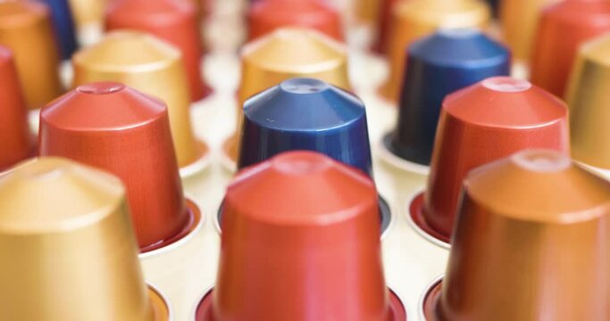 Tracking shot of several coffee capsules