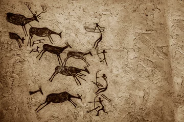 Fotobehang Cave art  pattern made of ancient wild animals, deers with horns  and hunters. Rock paintings Hunting scenes. palaeolithic Petroglyphs carved Stones background. people get food. shoot arrows from bows © Maxim Chuev