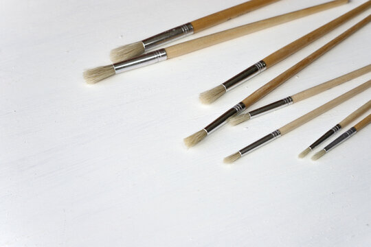 Set of white brushes on a case background. Artist accessories