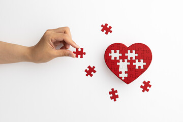 red heart shaped puzzle on white background