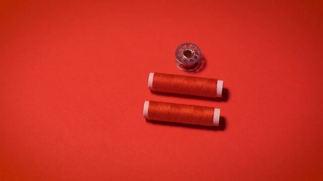 threads and zipper on a red minimalistic background