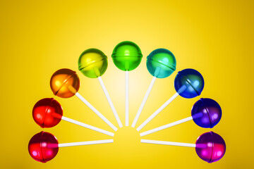 Colorful sweet round lollipop. 3d illustration with multicolored candy lined in a circle in rainbow...